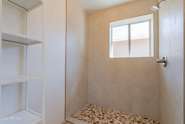 bathroom with a tile shower