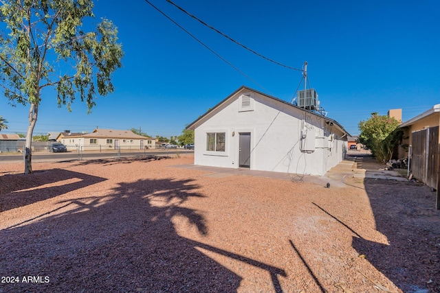 rear view of property with central air condition unit