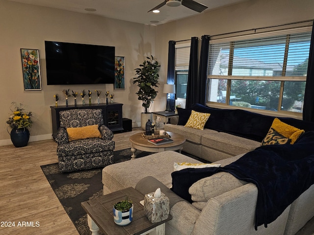 living room with hardwood / wood-style flooring and ceiling fan