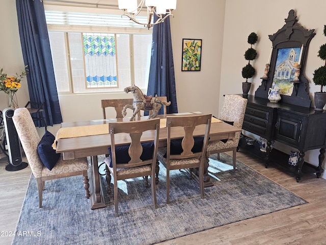 dining room featuring a notable chandelier and wood-type flooring