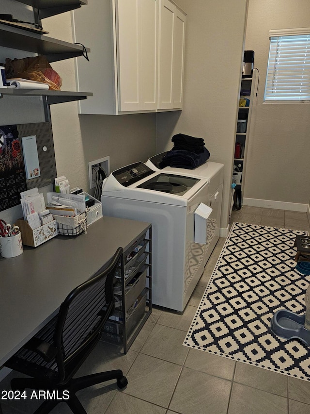 laundry area featuring washer and dryer, cabinets, and light tile patterned flooring