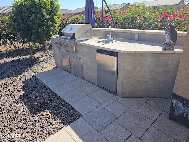 view of patio / terrace with sink, grilling area, and exterior kitchen