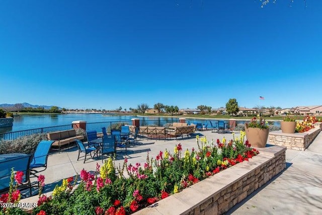 view of patio with a water view and an outdoor hangout area