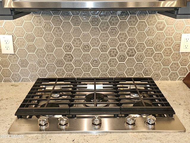 interior details with light stone counters and stainless steel gas stovetop