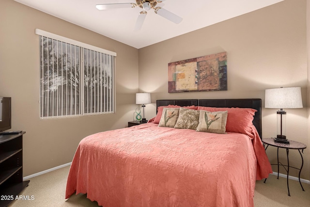 carpeted bedroom with a ceiling fan and baseboards