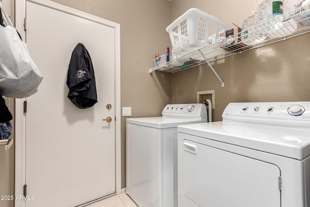 laundry area with laundry area, light tile patterned floors, and separate washer and dryer