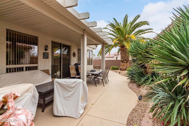 view of patio / terrace featuring fence and outdoor dining area