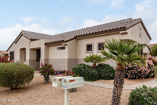 mediterranean / spanish-style house with a tiled roof and stucco siding