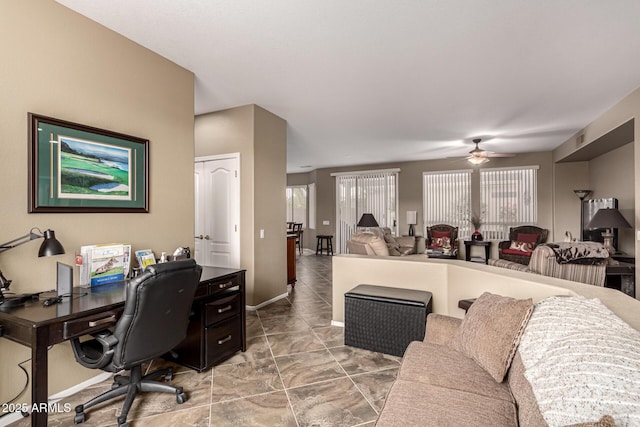 office area featuring baseboards, visible vents, and a ceiling fan