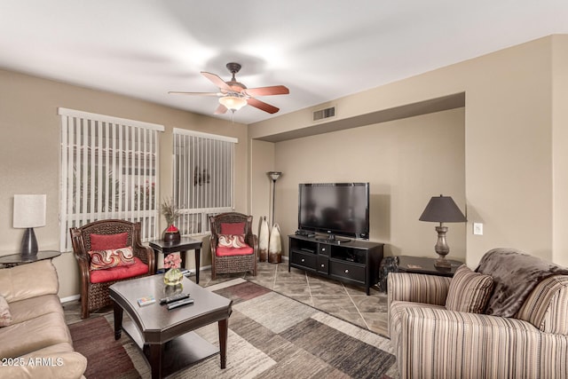 living room featuring visible vents and a ceiling fan