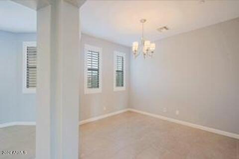 empty room with a notable chandelier