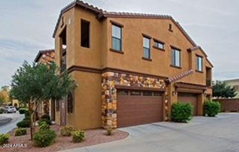 mediterranean / spanish house with a garage