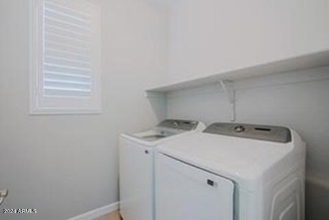 clothes washing area featuring separate washer and dryer