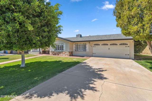 710 E Hayward Ave, Phoenix, AZ 85020 - single story home featuring stone siding, a garage, concrete driveway, a front lawn, and a chimney