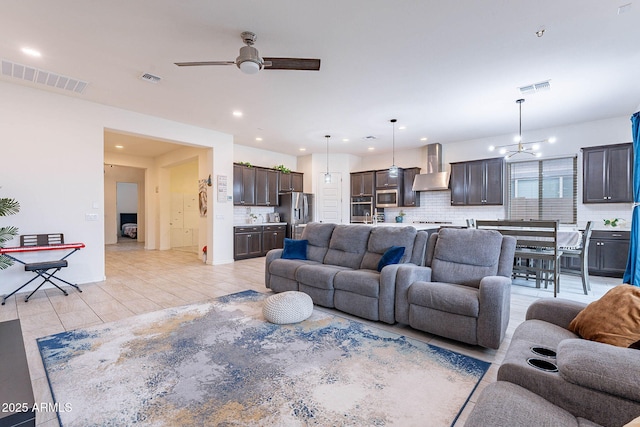 22960 N 94th Ln, Peoria, AZ 85383 - living room featuring a ceiling fan, recessed lighting, and a chandelier