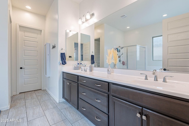 22960 N 94th Ln, Peoria, AZ 85383 - full bathroom with a stall shower, double vanity, and baseboards