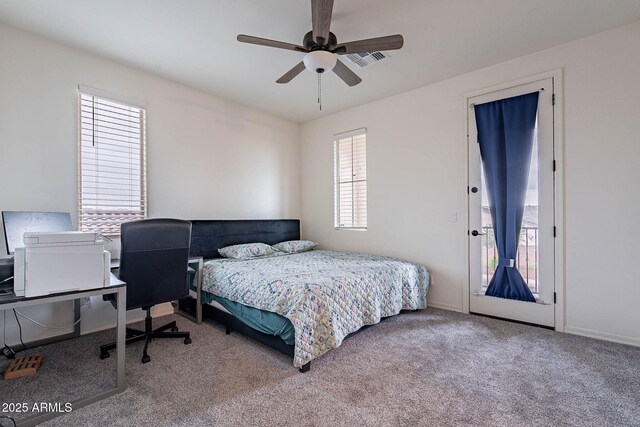 22960 N 94th Ln, Peoria, AZ 85383 - carpeted bedroom featuring access to exterior, baseboards, a ceiling fan, and an office area