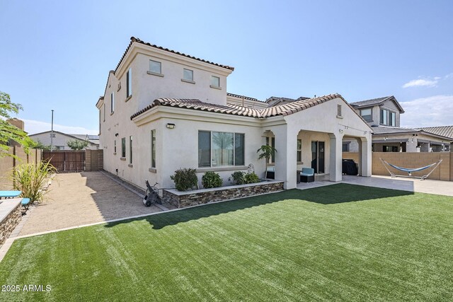 22960 N 94th Ln, Peoria, AZ 85383 - mediterranean / spanish-style home with stucco siding, a tiled roof, and a patio area