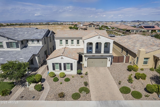 22960 N 94th Ln, Peoria, AZ 85383 - mediterranean / spanish-style house with a residential view, a balcony, driveway, a tiled roof, and stucco siding