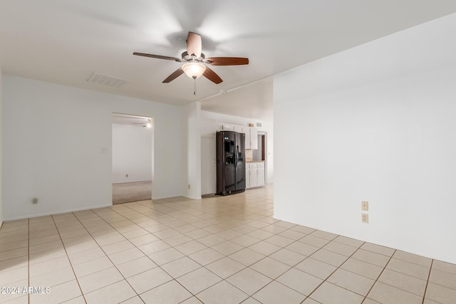 unfurnished room with ceiling fan and light tile patterned floors