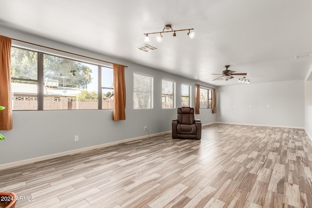 unfurnished room featuring ceiling fan and light wood-type flooring