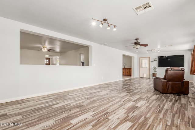 living room with ceiling fan and light hardwood / wood-style flooring