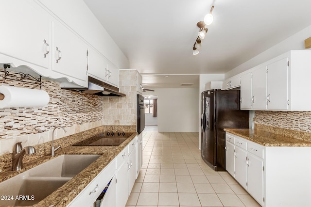 kitchen featuring black appliances, white cabinets, sink, and dark stone counters