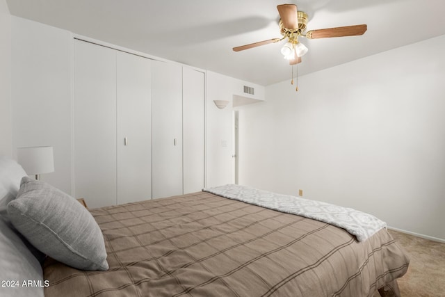 bedroom with carpet flooring, ceiling fan, and a closet