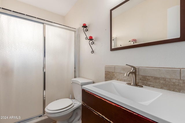 bathroom with vanity, toilet, walk in shower, and backsplash