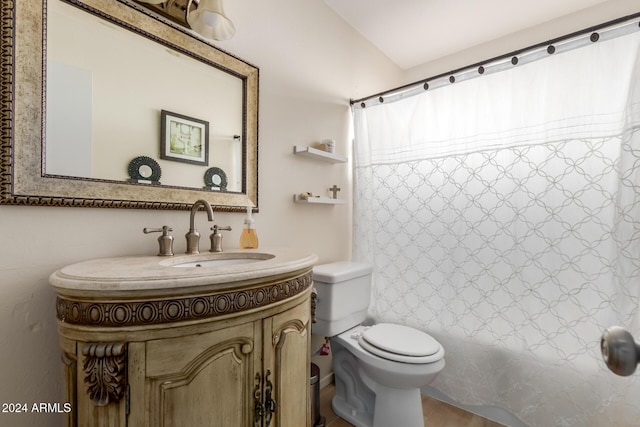 full bathroom with hardwood / wood-style floors, vanity, shower / tub combo, and toilet