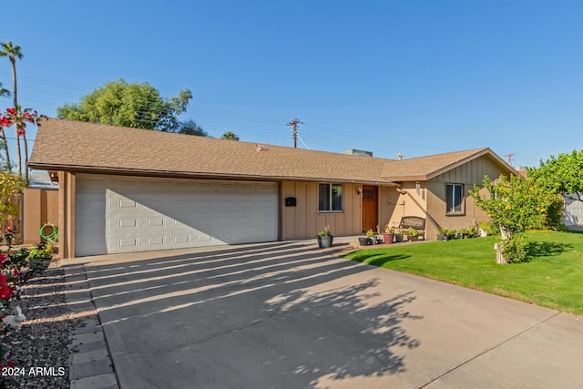 single story home with a front yard and a garage