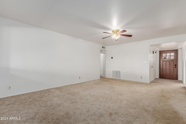 spare room with light carpet and ceiling fan