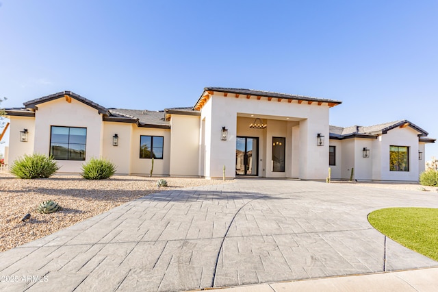 10918 W Dove Roost Rd, Queen Creek, AZ 85144 - mediterranean / spanish-style house featuring stucco siding, a tile roof, and curved driveway