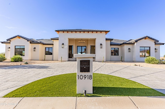 10918 W Dove Roost Rd, Queen Creek, AZ 85144 - mediterranean / spanish house featuring stucco siding, a tiled roof, and curved driveway