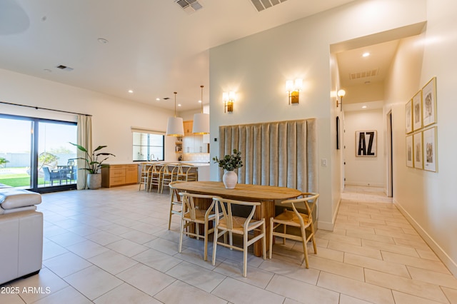 10918 W Dove Roost Rd, Queen Creek, AZ 85144 - dining space featuring light tile patterned floors, recessed lighting, a high ceiling, and baseboards