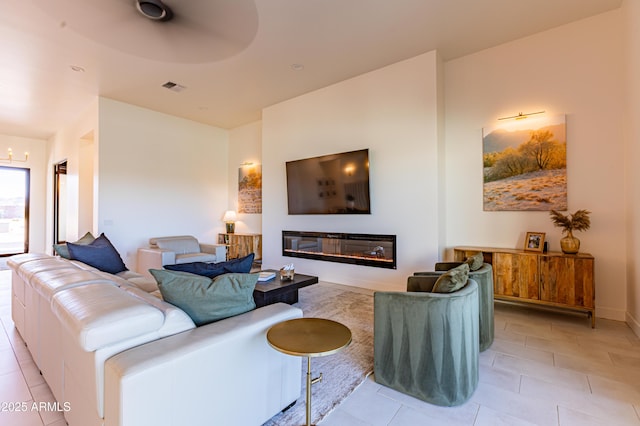 10918 W Dove Roost Rd, Queen Creek, AZ 85144 - living room featuring light tile patterned flooring and a glass covered fireplace