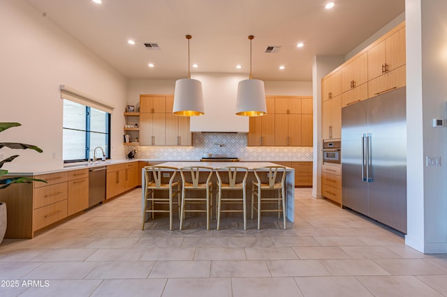 10918 W Dove Roost Rd, Queen Creek, AZ 85144 - kitchen with appliances with stainless steel finishes, light brown cabinetry, tasteful backsplash, modern cabinets, and recessed lighting