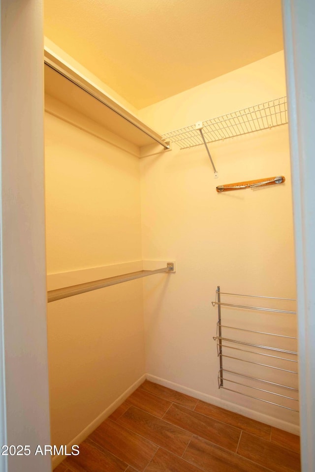 spacious closet featuring wood finish floors