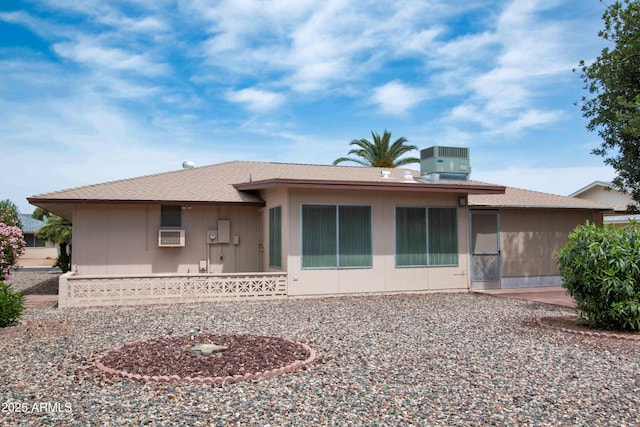 rear view of house with central AC unit