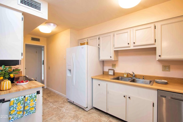 kitchen with dishwasher, a sink, white fridge with ice dispenser, and visible vents
