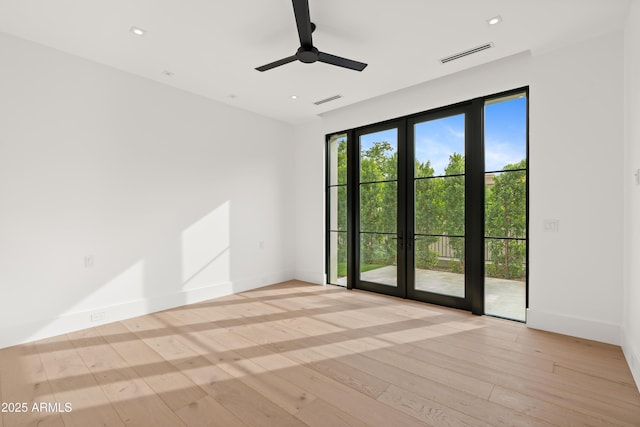 unfurnished room with recessed lighting, visible vents, and light wood-style floors