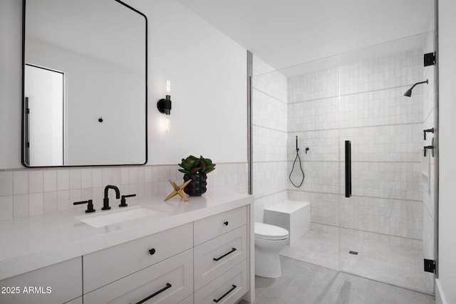 full bath featuring a shower stall, tile walls, toilet, tile patterned floors, and vanity