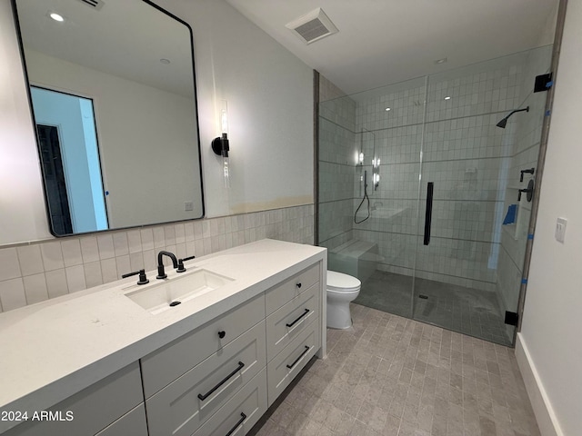 bathroom featuring vanity, visible vents, a stall shower, tile walls, and toilet