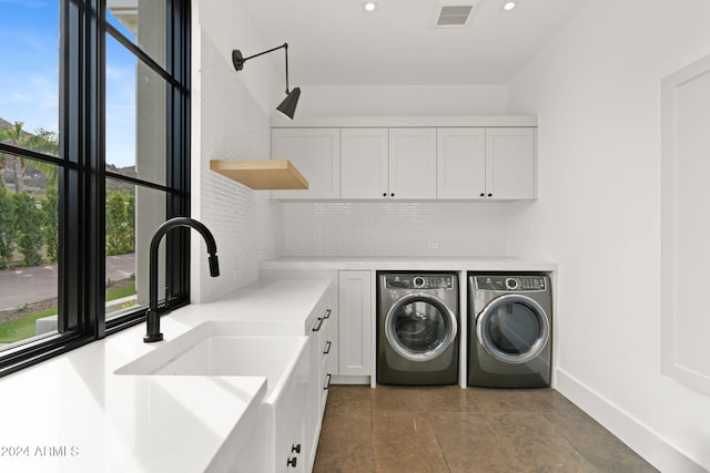 washroom featuring visible vents, washer and clothes dryer, recessed lighting, cabinet space, and a sink