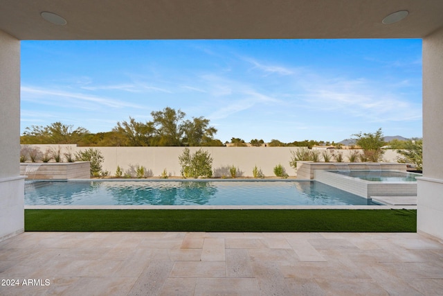 view of swimming pool with a patio area, a fenced in pool, an in ground hot tub, and a fenced backyard