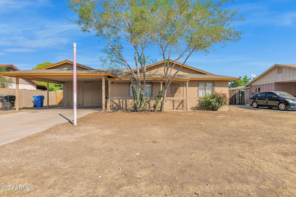 single story home featuring a carport