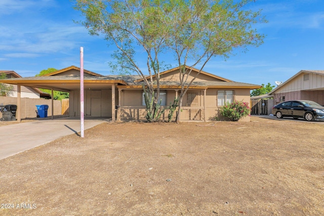 single story home featuring a carport