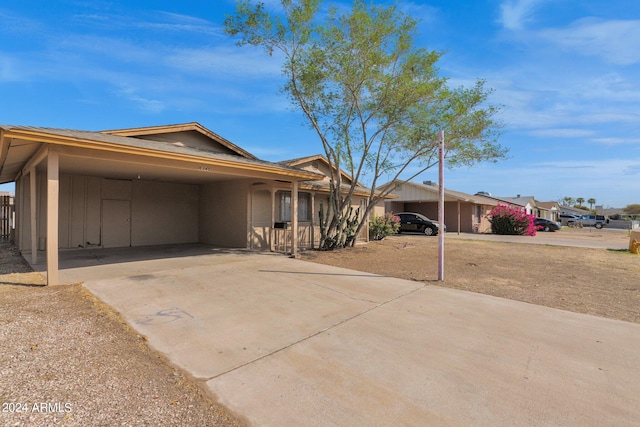 ranch-style home featuring a carport