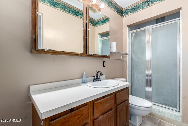 bathroom with tile patterned floors, vanity, toilet, and a shower with shower door