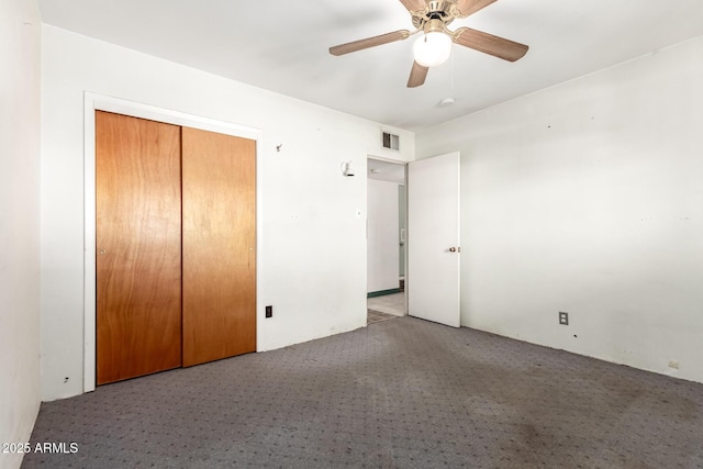 unfurnished bedroom featuring light carpet, a closet, and ceiling fan